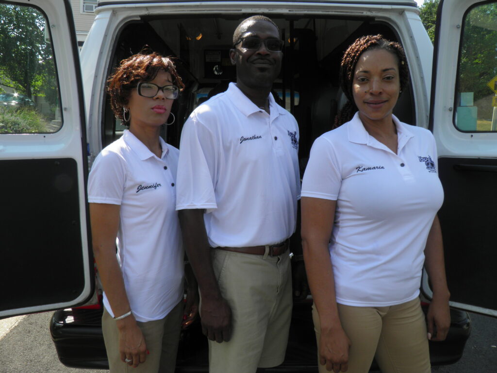 A man and two women standing